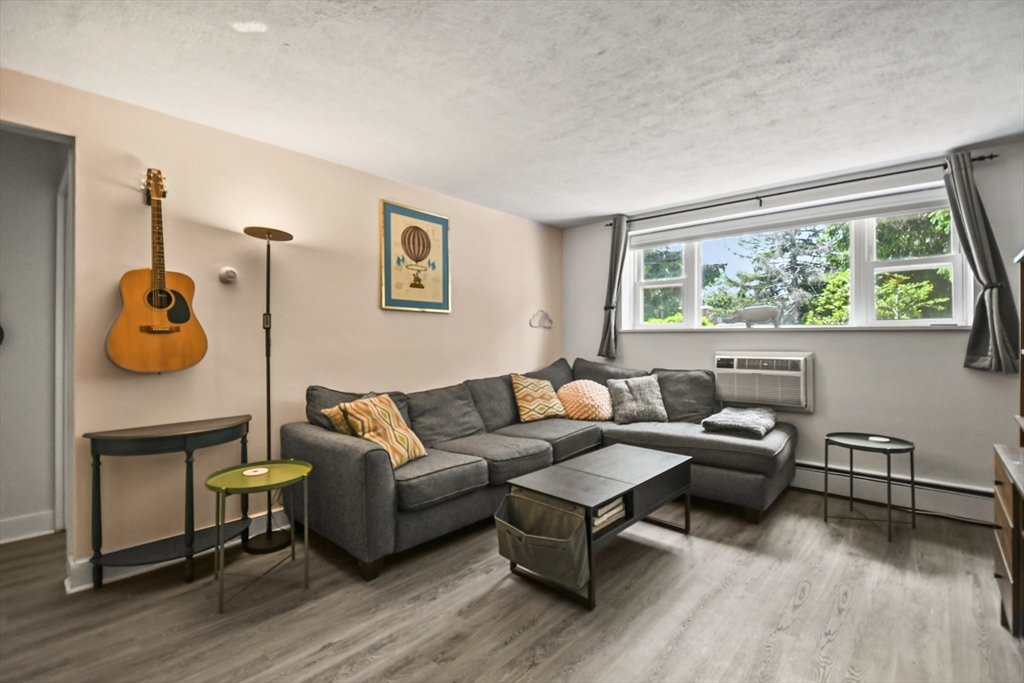 1105 Lexington Street, Unit 102 Waltham, MA 02452 - Photo 6 of 41 a living room with furniture and a table