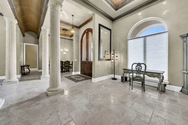 a view of a dining room with furniture and a chandelier