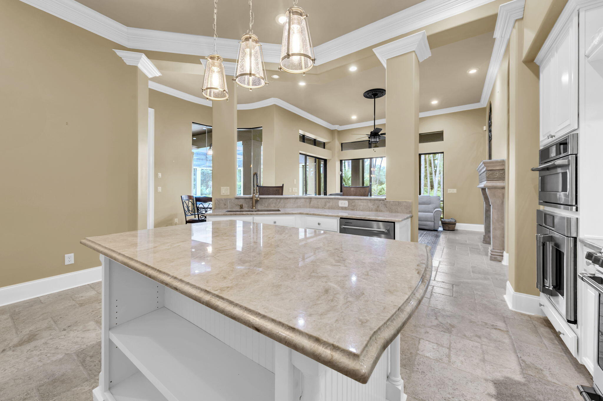 428 Captains Circle Destin, FL 32541 - Photo 22 of 68 a large kitchen with kitchen island a stove a sink and a dining table