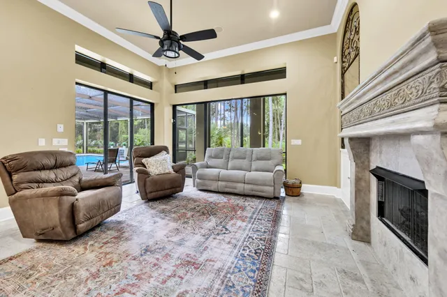 a living room with furniture and a ceiling fan