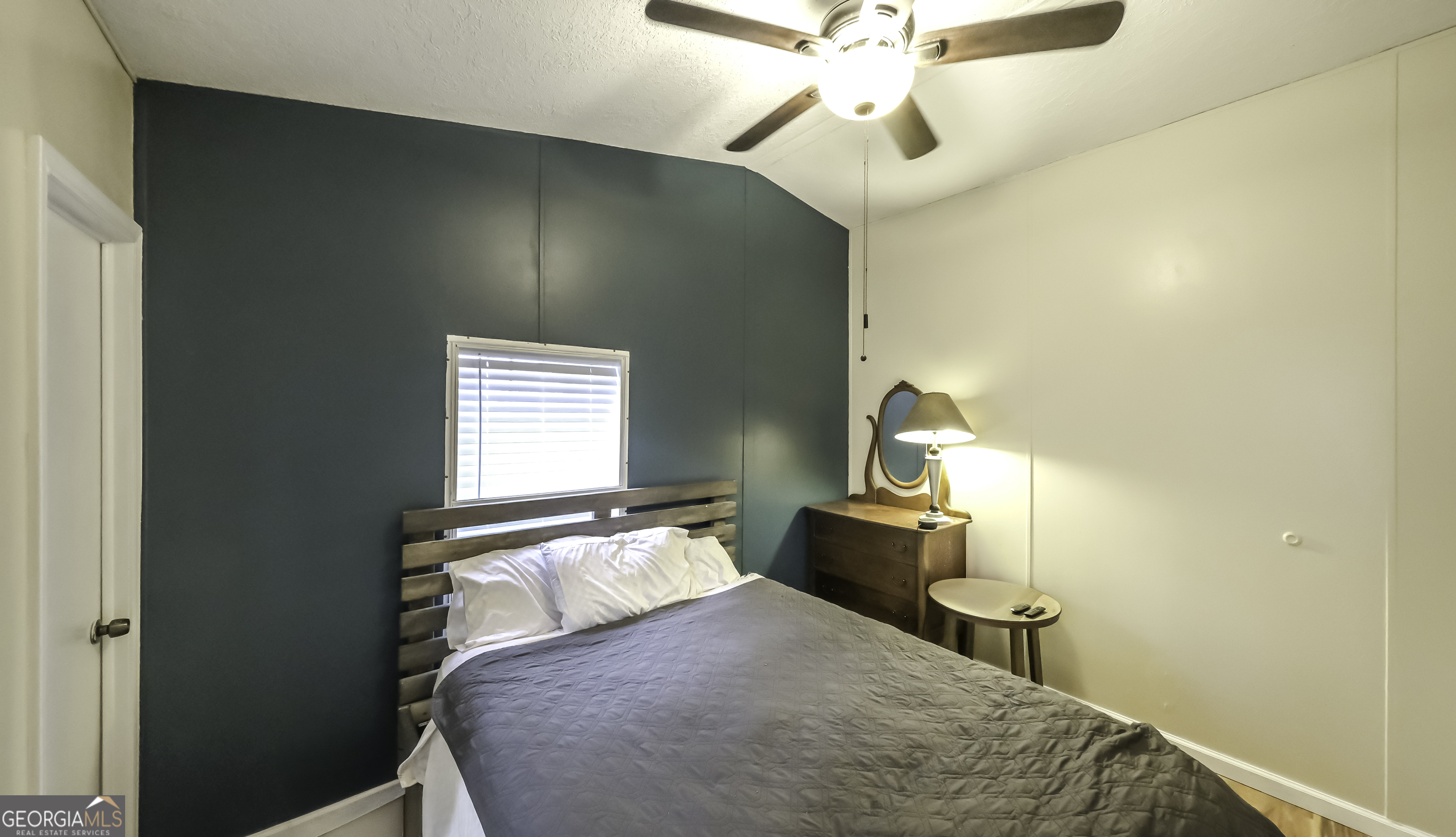 91 Holder Road Temple, GA 30179 - Photo 32 of 40 a bedroom with a bed and a chandelier