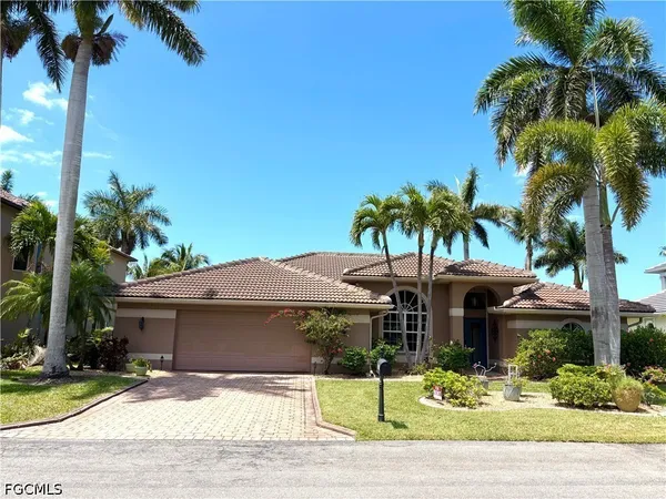 a view of house with outdoor space and palm tree