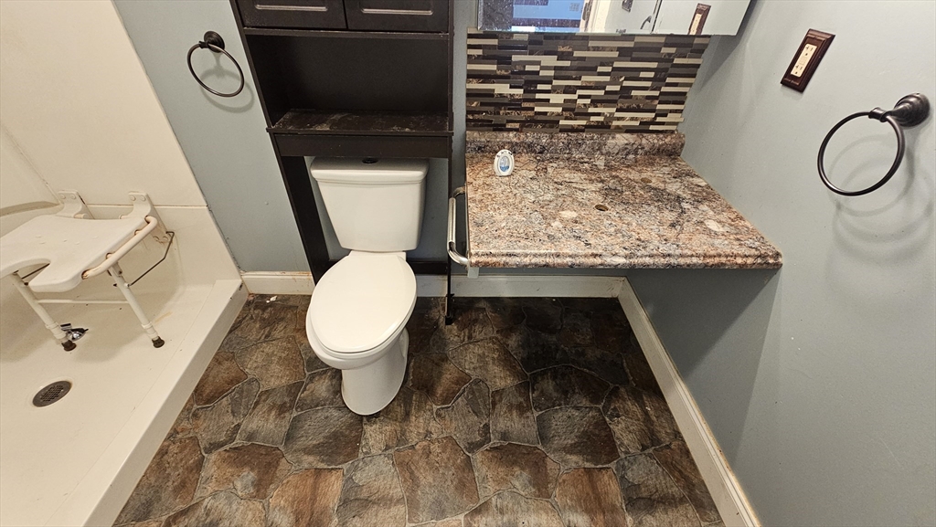 179 Oak Street Springfield, MA 01151 - Photo 12 of 28 a bathroom with a toilet and a shower