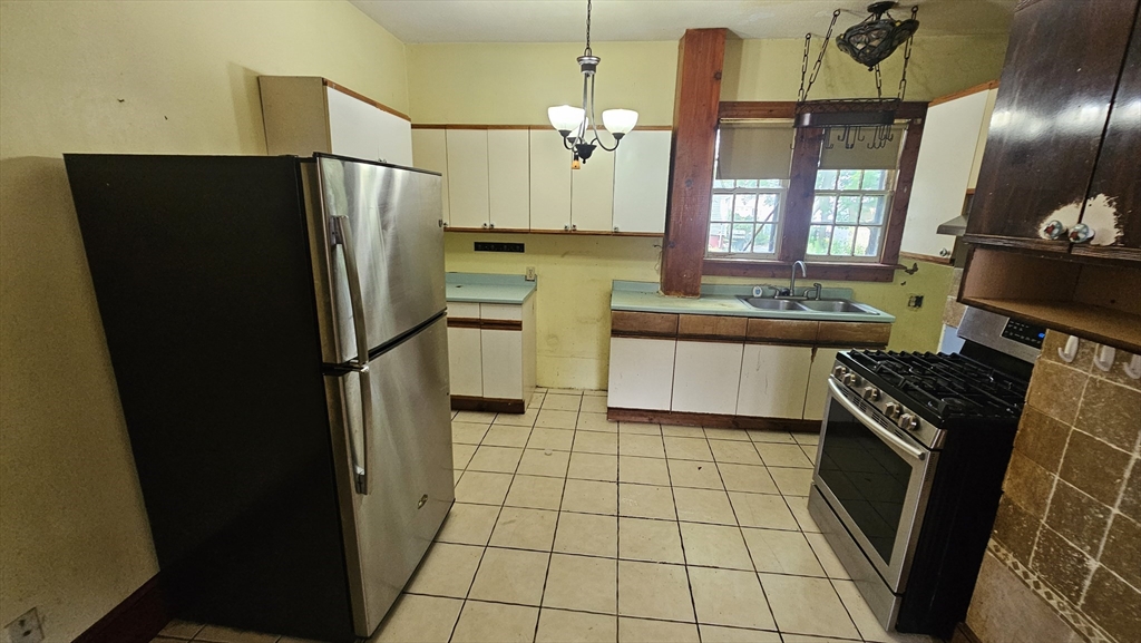 179 Oak Street Springfield, MA 01151 - Photo 13 of 28 a kitchen with stainless steel appliances a refrigerator sink and stove