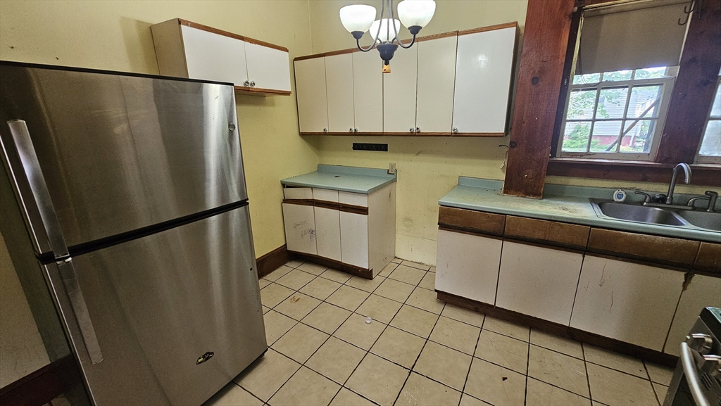 179 Oak Street Springfield, MA 01151 - Photo 15 of 28 a kitchen with stainless steel appliances a refrigerator and a sink