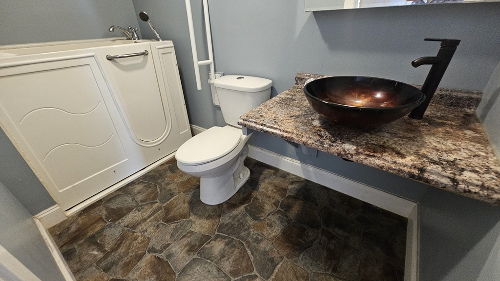 179 Oak Street Springfield, MA 01151 - Photo 22 of 28 a bathroom with a toilet and a mirror