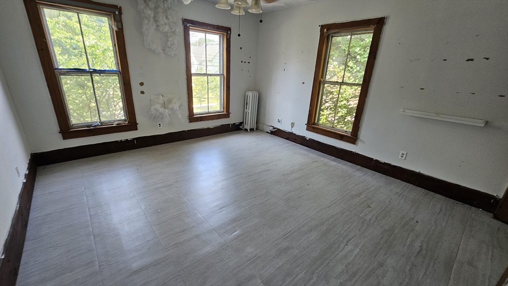 179 Oak Street Springfield, MA 01151 - Photo 24 of 28 an empty room with wooden floor and windows