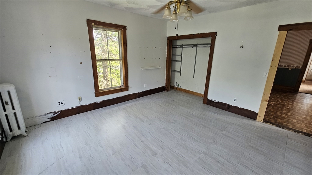 179 Oak Street Springfield, MA 01151 - Photo 25 of 28 an empty room with wooden floor and windows
