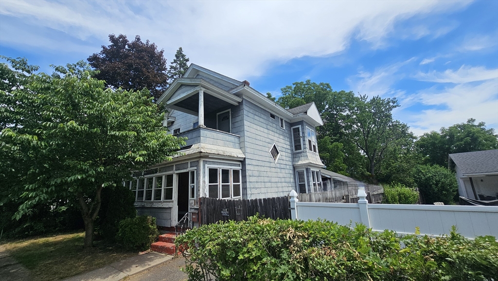 179 Oak Street Springfield, MA 01151 - Photo 3 of 28 front view of a house with a yard
