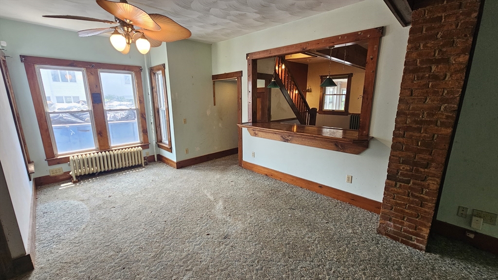 179 Oak Street Springfield, MA 01151 - Photo 10 of 28 a view of a room with a fireplace and a window