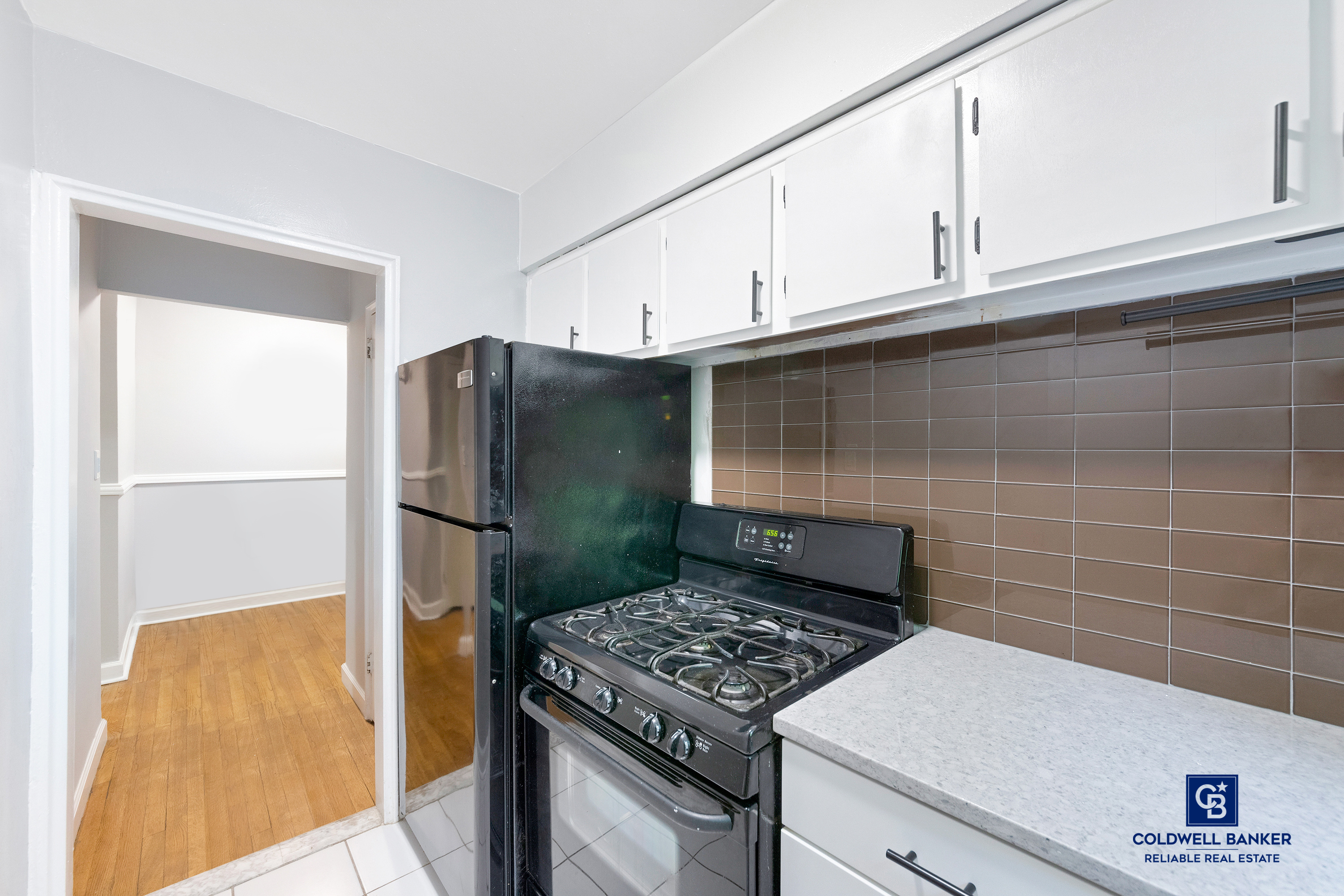 5235 Post Road, Unit 2C Bronx, NY 10471 - Photo 4 of 10 a kitchen with stainless steel appliances granite countertop a refrigerator and a stove