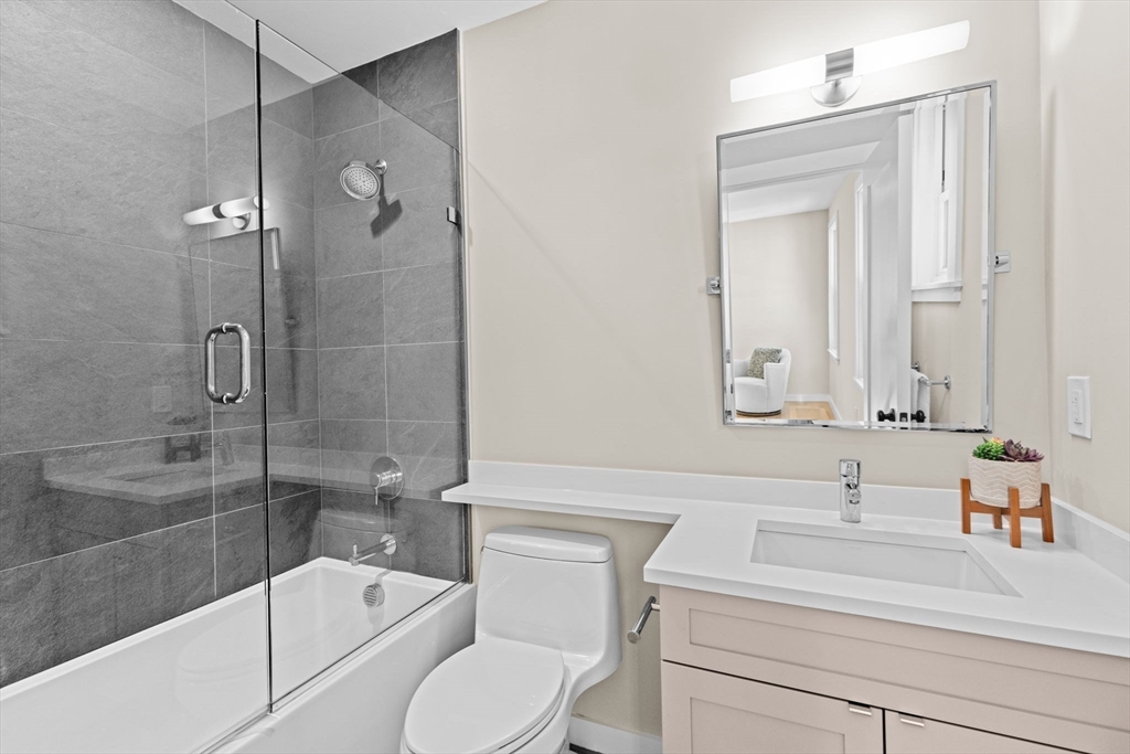 56-58 Perry Street, Unit 4 Brookline, MA 02446 - Photo 11 of 17 a bathroom with a sink a toilet and shower