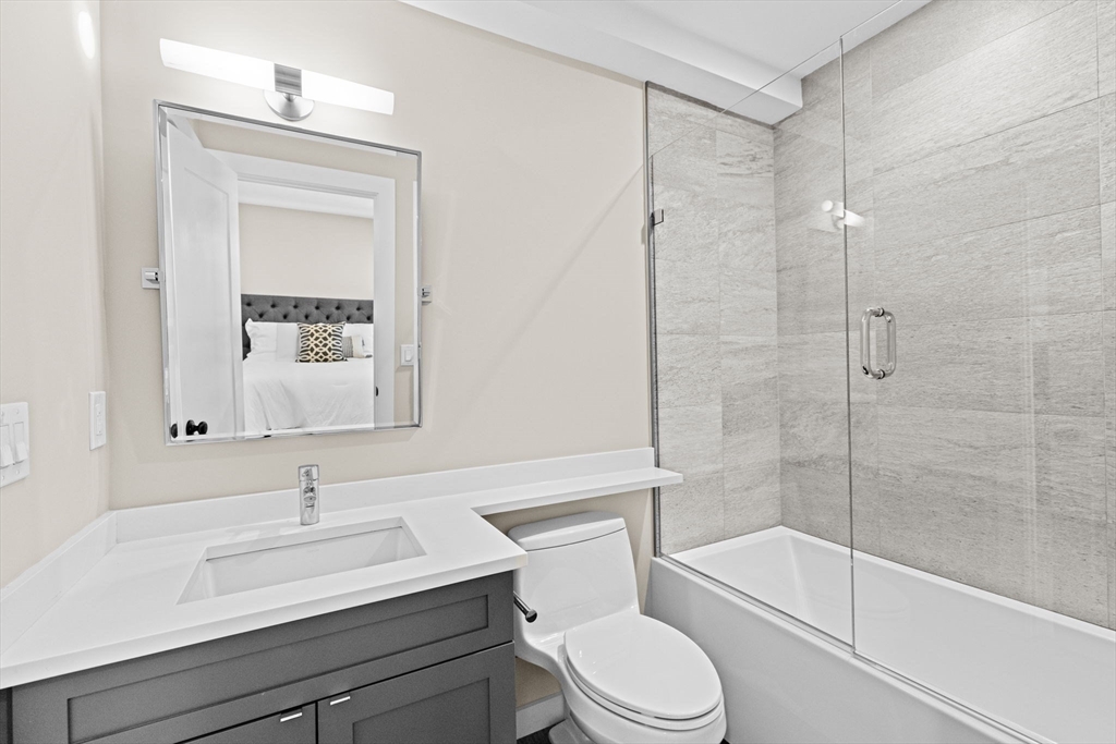 56-58 Perry Street, Unit 4 Brookline, MA 02446 - Photo 12 of 17 a bathroom with a sink a toilet and shower
