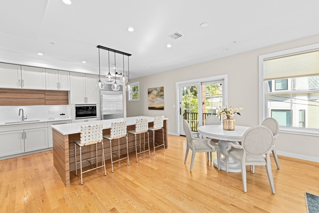 56-58 Perry Street, Unit 4 Brookline, MA 02446 - Photo 2 of 17 a living room with furniture a dining table and a large window