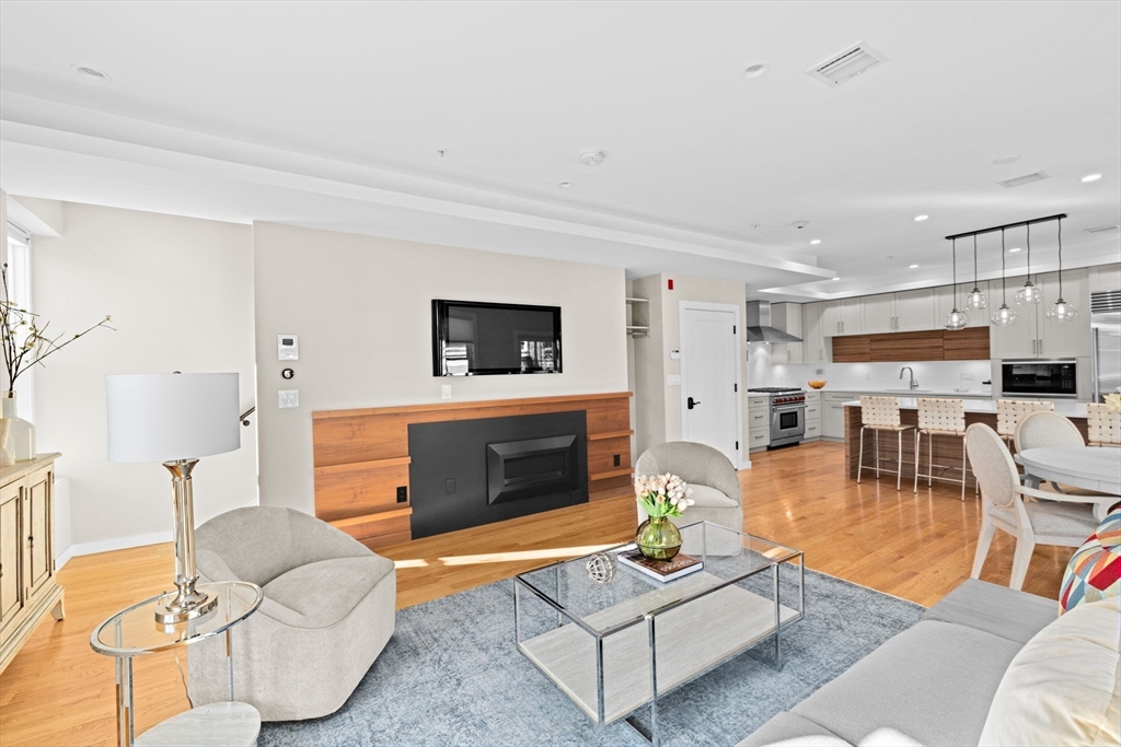 56-58 Perry Street, Unit 4 Brookline, MA 02446 - Photo 6 of 17 a living room with furniture and a fireplace