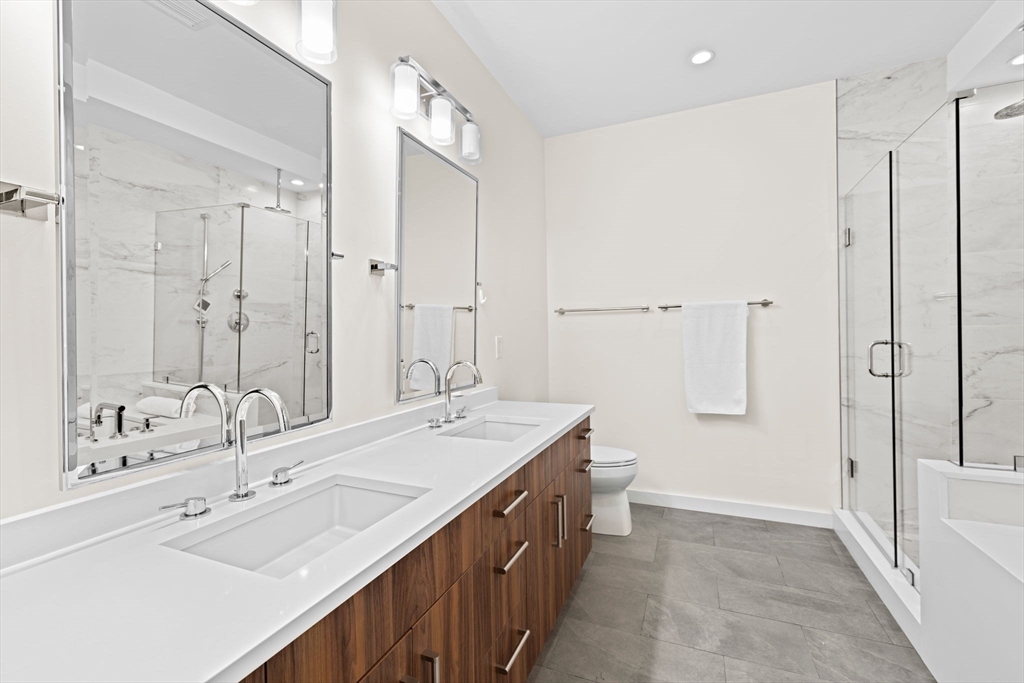 56-58 Perry Street, Unit 4 Brookline, MA 02446 - Photo 9 of 17 a bathroom with a double vanity sink mirror double and shower
