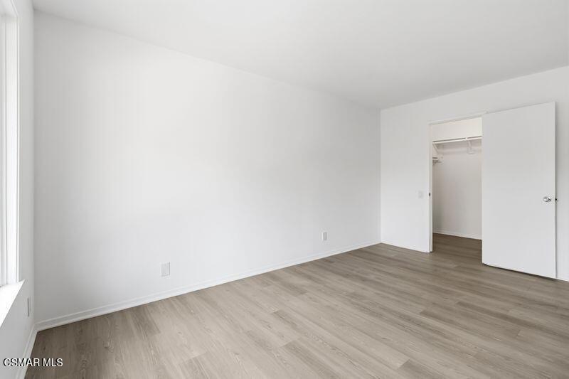 584 Rio Grande Circle Thousand Oaks, CA 91360 - Photo 11 of 19 a view of an empty room with wooden floor and a window