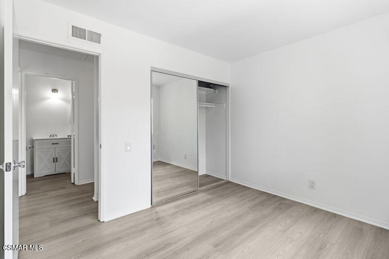 584 Rio Grande Circle Thousand Oaks, CA 91360 - Photo 16 of 19 an empty room with wooden floor and a bathroom