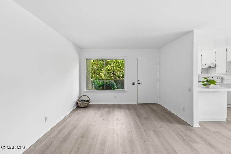 584 Rio Grande Circle Thousand Oaks, CA 91360 - Photo 5 of 19 an empty room with wooden floor and windows