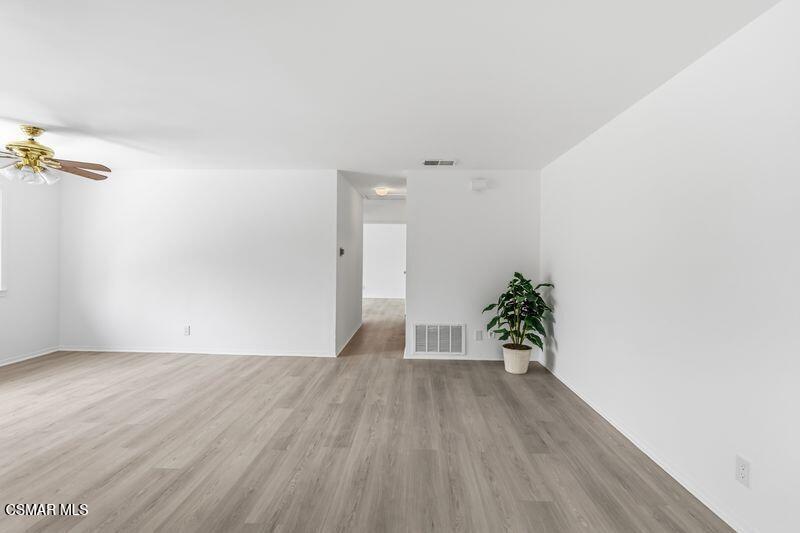 584 Rio Grande Circle Thousand Oaks, CA 91360 - Photo 9 of 19 an empty room with wooden floor and a potted plant