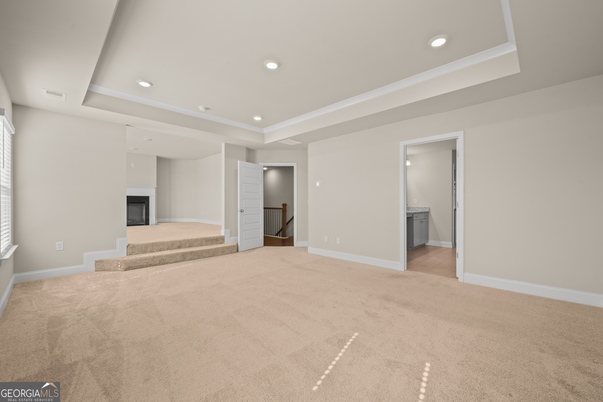 324 Conley Avenue Hampton, GA 30228 - Photo 28 of 59 a view of an empty room with wooden floor and a kitchen
