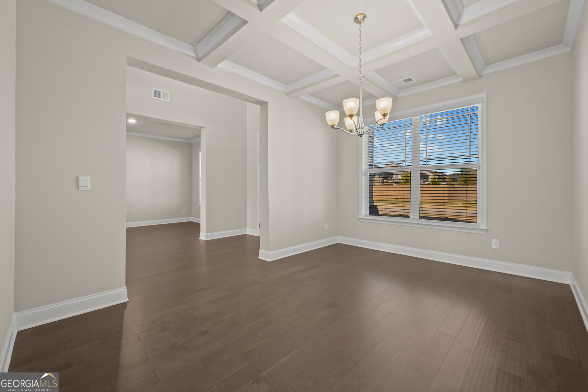 324 Conley Avenue Hampton, GA 30228 - Photo 8 of 59 an empty room with wooden floor chandelier and windows