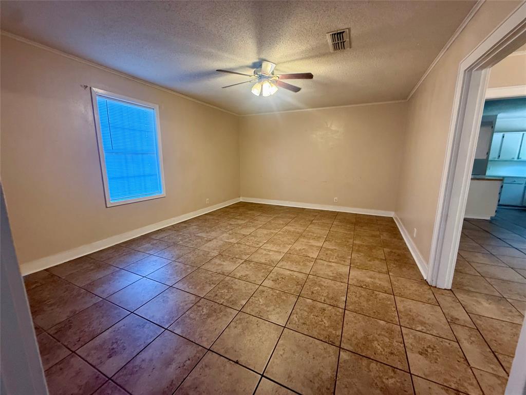 217 3rd St Pinehill Springhill, LA 71075 - Photo 18 of 23 Tiled flooring throughout this spacious room with a ceiling fan light fixture