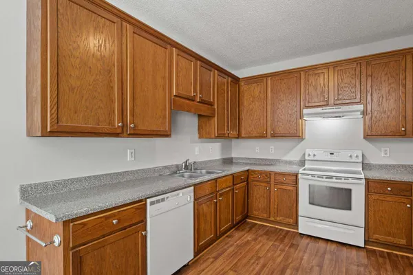 a kitchen with stainless steel appliances granite countertop a sink stove and cabinets