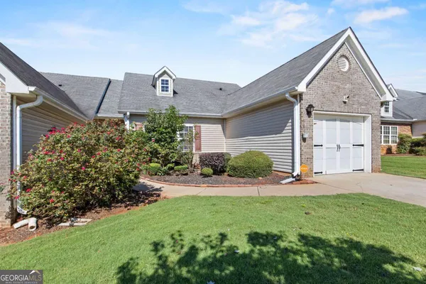 a front view of a house with a yard