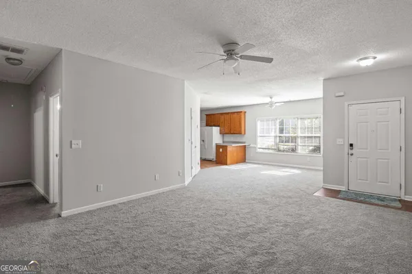 a view of a livingroom with a kitchen