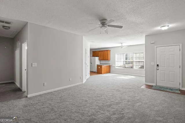 a view of a livingroom with a kitchen