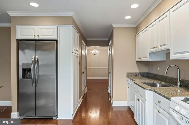 a kitchen with a refrigerator a sink and cabinets