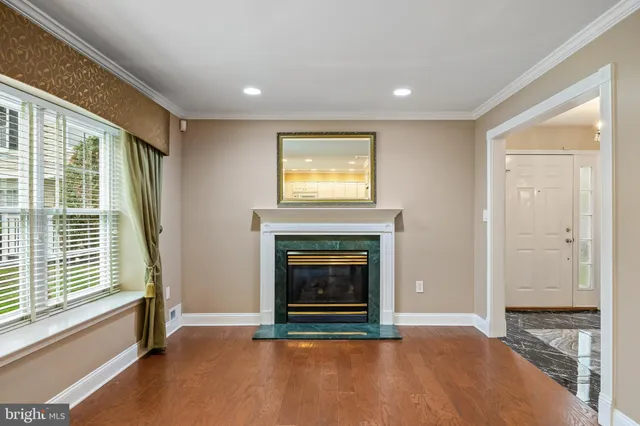 a view of an empty room with a fireplace and a window