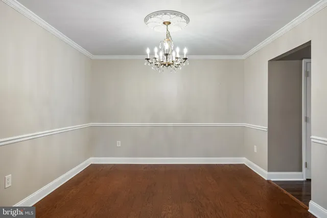a view of an empty room with chandelier