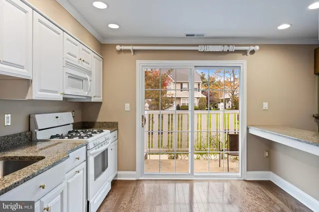 a kitchen with stainless steel appliances granite countertop a stove and a refrigerator