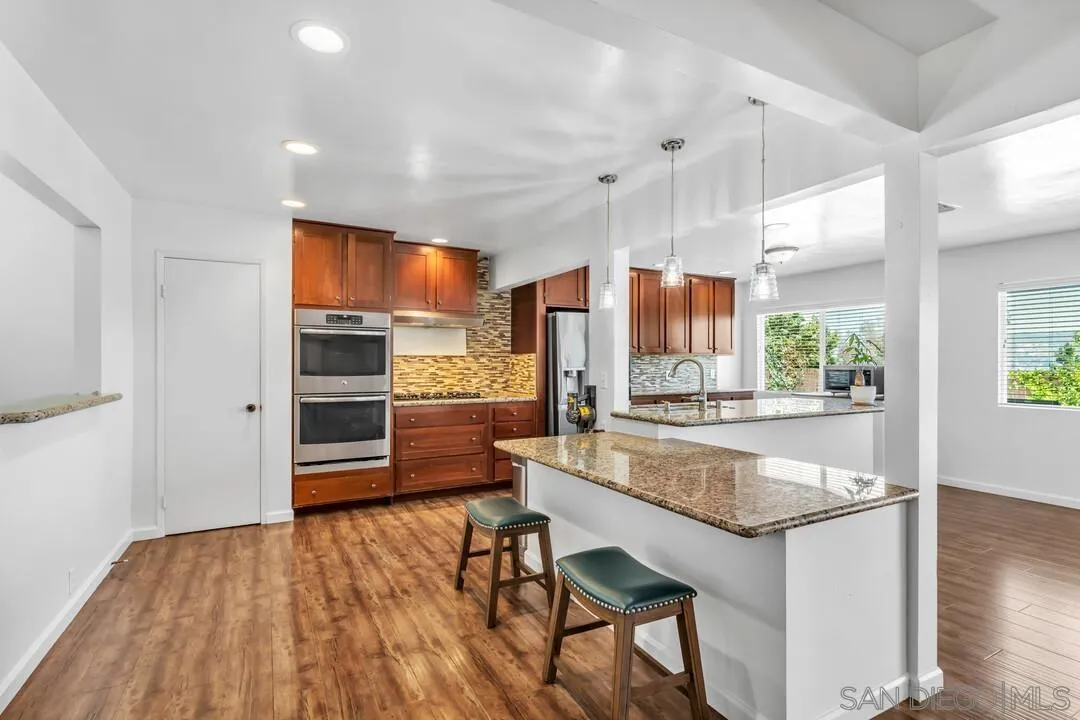 1509 Honey Hill Road El Cajon, CA 92020 - Photo 12 of 49 a kitchen with stainless steel appliances granite countertop a refrigerator and a sink