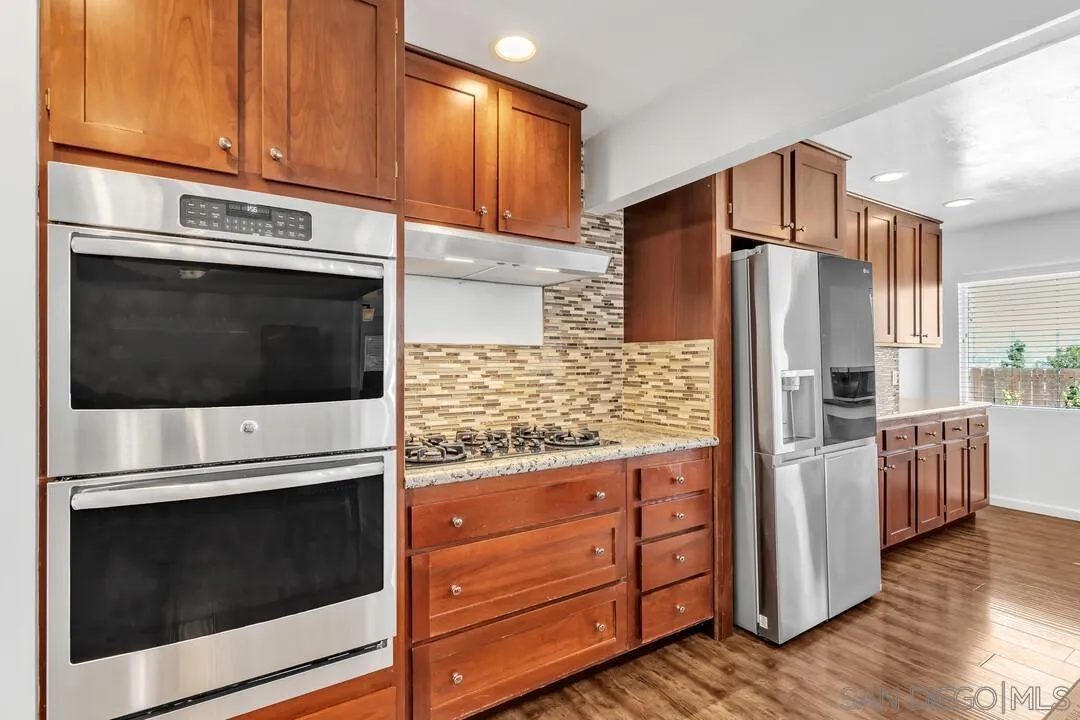1509 Honey Hill Road El Cajon, CA 92020 - Photo 14 of 49 a kitchen with granite countertop cabinets and steel stainless steel appliances