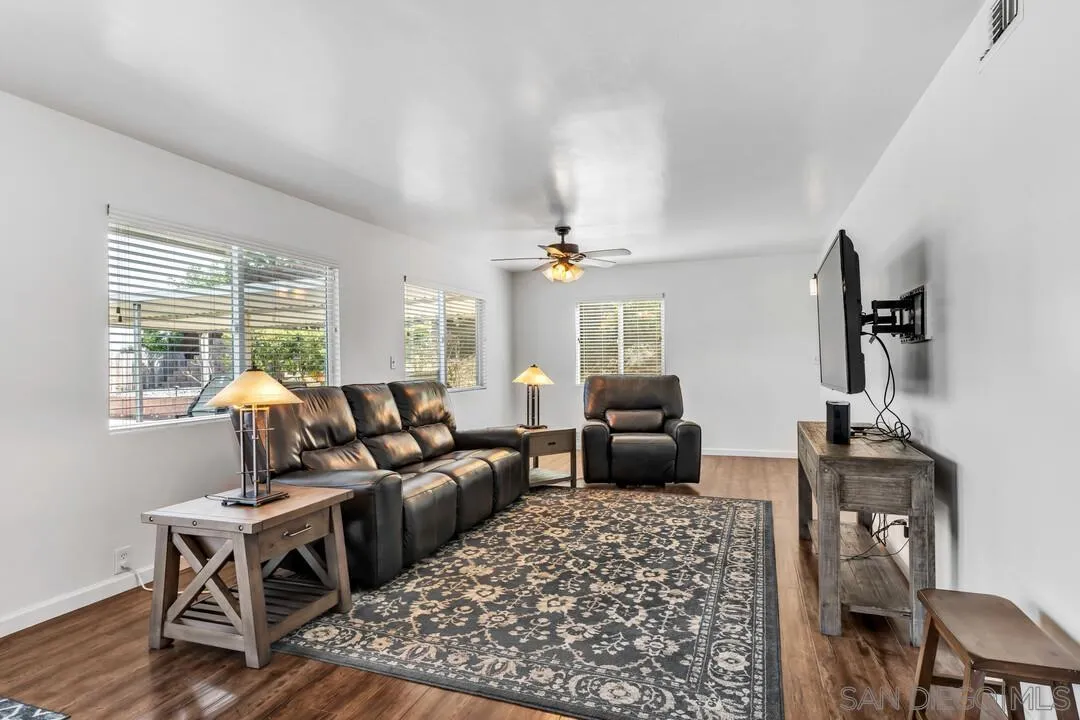 1509 Honey Hill Road El Cajon, CA 92020 - Photo 19 of 49 a living room with furniture a rug and a chandelier