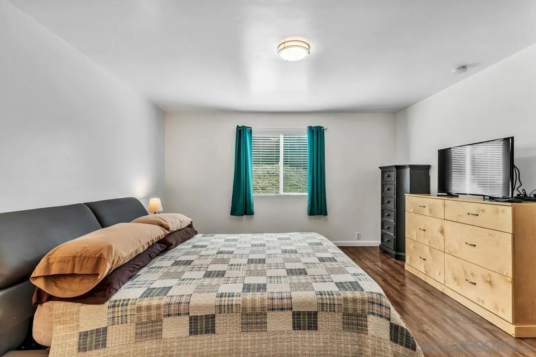 1509 Honey Hill Road El Cajon, CA 92020 - Photo 22 of 49 a bedroom with a bed and dresser with mirror