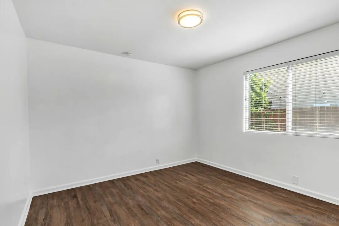 1509 Honey Hill Road El Cajon, CA 92020 - Photo 26 of 49 an empty room with wooden floor and windows