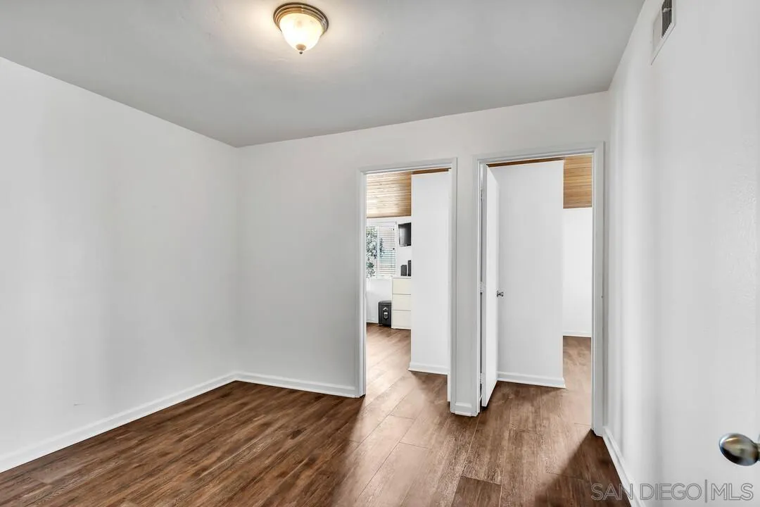 1509 Honey Hill Road El Cajon, CA 92020 - Photo 27 of 49 an empty room with wooden floor and windows