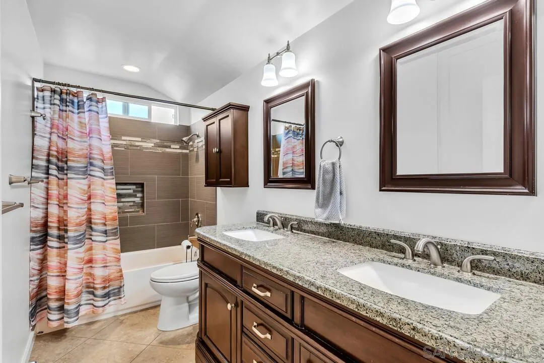 1509 Honey Hill Road El Cajon, CA 92020 - Photo 31 of 49 a bathroom with a granite countertop sink mirror vanity and toilet