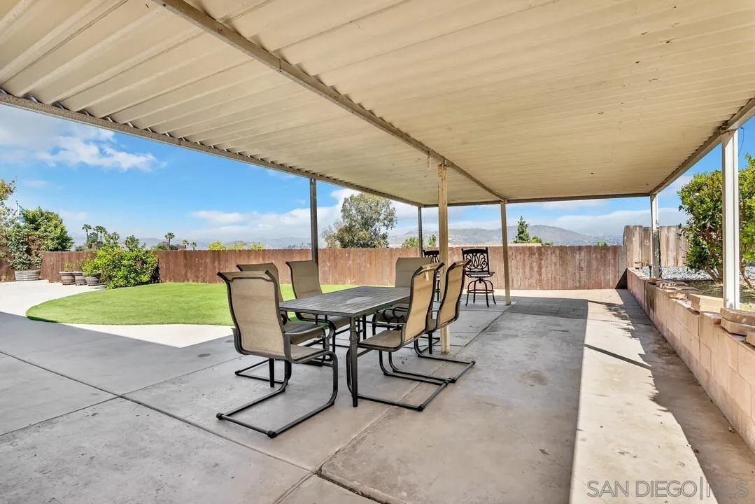 1509 Honey Hill Road El Cajon, CA 92020 - Photo 43 of 49 a view of a patio with a table chairs and backyard