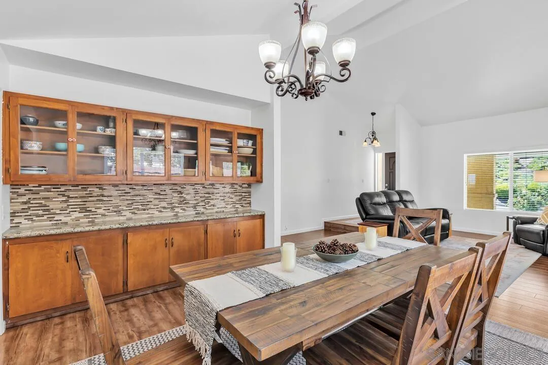 1509 Honey Hill Road El Cajon, CA 92020 - Photo 9 of 49 a view of a dining room with furniture a chandelier and wooden floor
