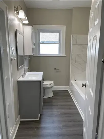 a bathroom with a sink a toilet a shower and a mirror
