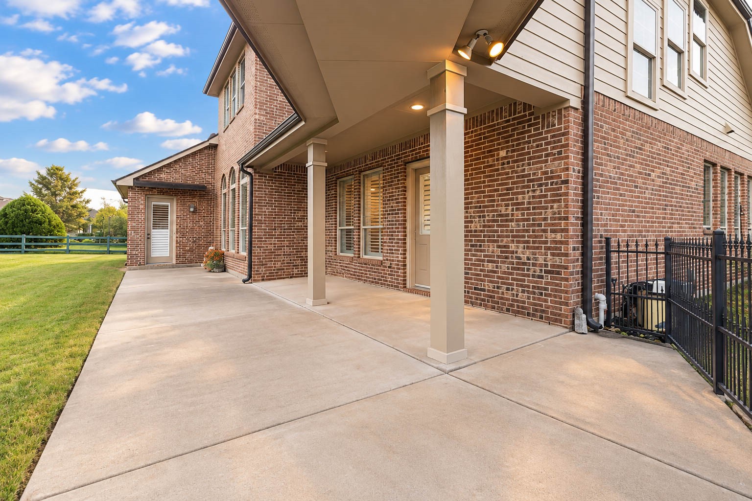 5403 Mesquite Ridge Street Fulshear, TX 77441 - Photo 35 of 42 Step outside to a covered patio that is made for outdoor living, with a broad concrete pad that easily fits a dining set and lounge seating. Recessed lighting extends the evenings, and multiple doors from the home lead directly to the backyard.