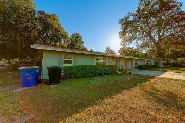a front view of house with yard and trees