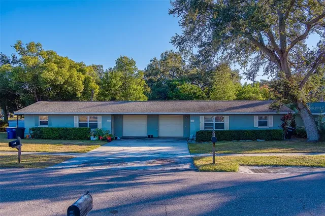 a view of a house with swimming pool and next to a yard