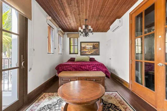 a bedroom with a large bed and a chandelier