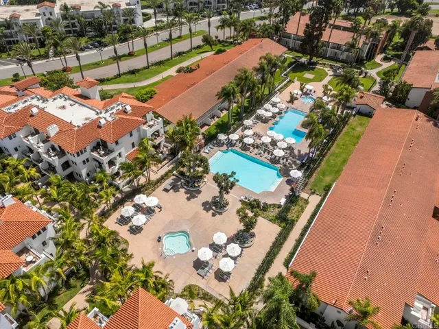 an aerial view of a house with a garden and lake view